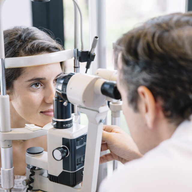 Eye Doctor examinating a young patient