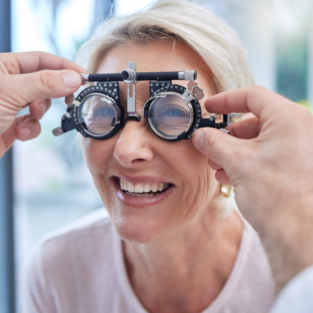 Happy customer in a vision test or eye exam for eyesight by doctor, optometrist or ophthalmologist .